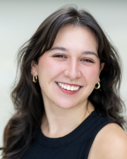 woman with brown curly hair smiling